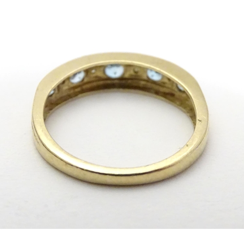 458 - A 9ct gold ring set with topaz and diamond in a linear setting. ring size approx K 1/2