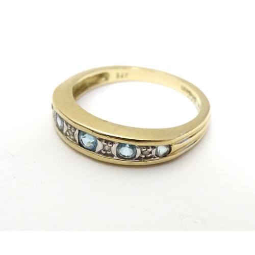 458 - A 9ct gold ring set with topaz and diamond in a linear setting. ring size approx K 1/2