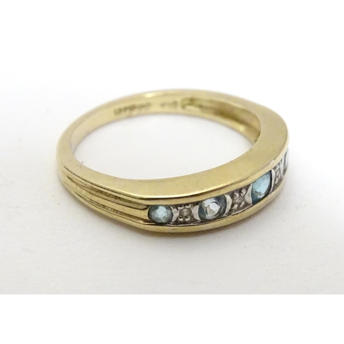 458 - A 9ct gold ring set with topaz and diamond in a linear setting. ring size approx K 1/2