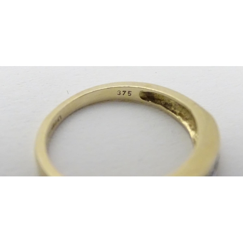 458 - A 9ct gold ring set with topaz and diamond in a linear setting. ring size approx K 1/2