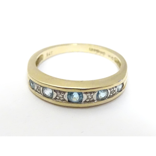 458 - A 9ct gold ring set with topaz and diamond in a linear setting. ring size approx K 1/2