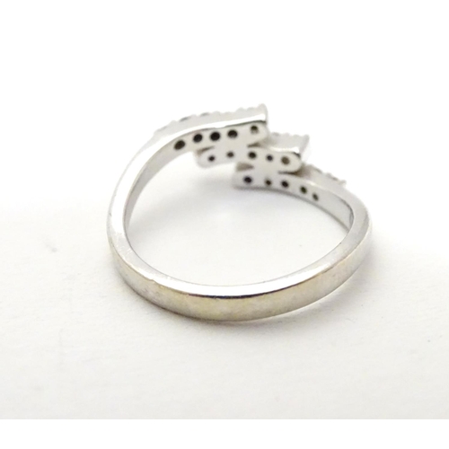 459 - An 18ct white gold ring set with three bands of 5 white stones. Ring size approx H