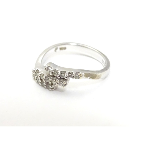 459 - An 18ct white gold ring set with three bands of 5 white stones. Ring size approx H