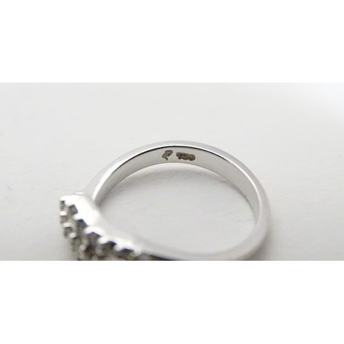 459 - An 18ct white gold ring set with three bands of 5 white stones. Ring size approx H