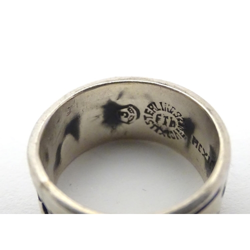 462 - A Mexican silver ring of band form with abstract detail. Ring size approx. O