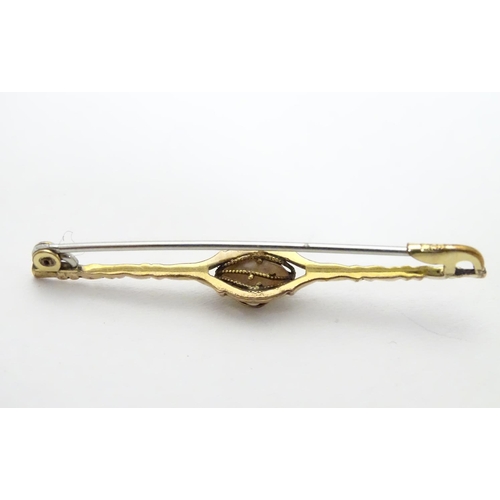 489 - A yellow metal bar brooch set with central pearl  2