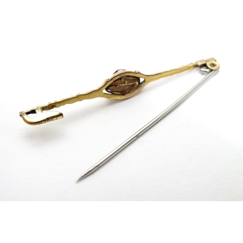 489 - A yellow metal bar brooch set with central pearl  2