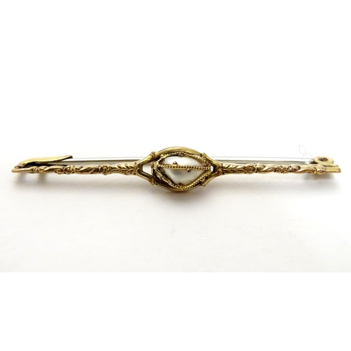 489 - A yellow metal bar brooch set with central pearl  2