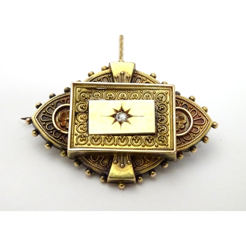 501 - A Victorian 15ct gold brooch set with central diamond. 1 1/2