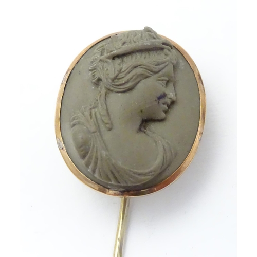 515 - A Victorian yellow metal stick pin set with larva cameo to top, 3 1/2