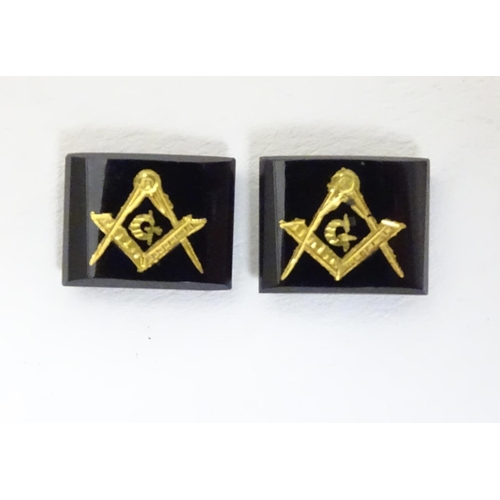 517 - Two onyx stones set with gilt masonic symbols. Approx 1/4