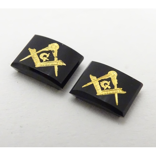 517 - Two onyx stones set with gilt masonic symbols. Approx 1/4