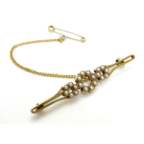 525 - A late 19thC / early 20thC 15ct gold brooch set with seed pearls. 1 7/8