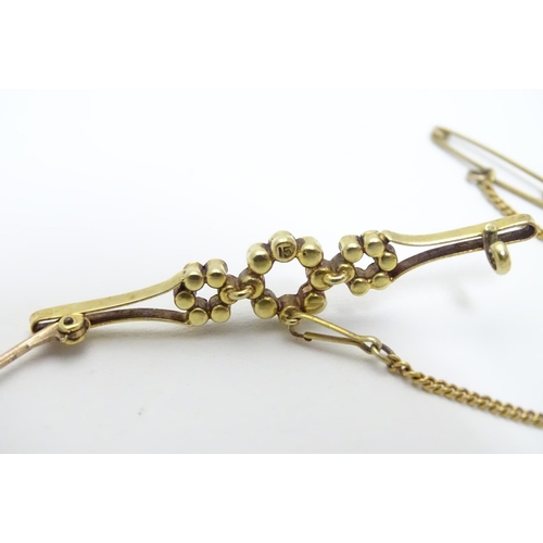 525 - A late 19thC / early 20thC 15ct gold brooch set with seed pearls. 1 7/8