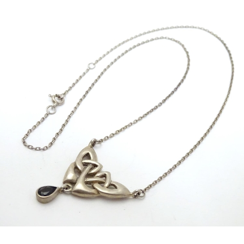 526 - A silver pendant and chain necklace with Celtic style decoration approx 16