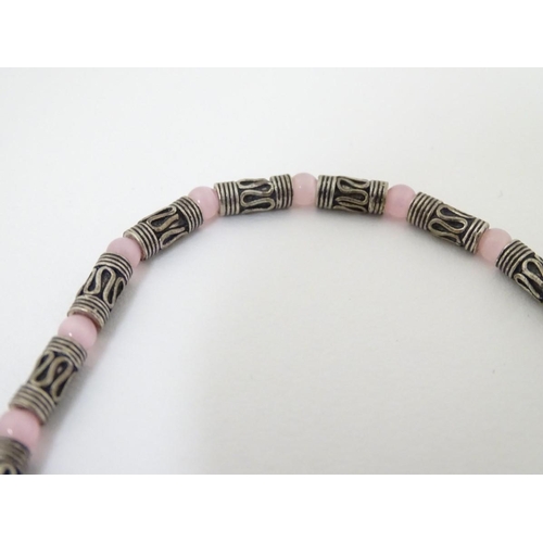 535 - A silver and white metal necklace set with pink cats eye beads. Approx 16'' long