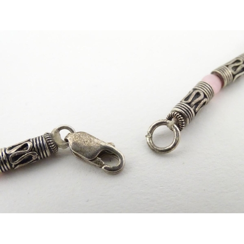 535 - A silver and white metal necklace set with pink cats eye beads. Approx 16'' long