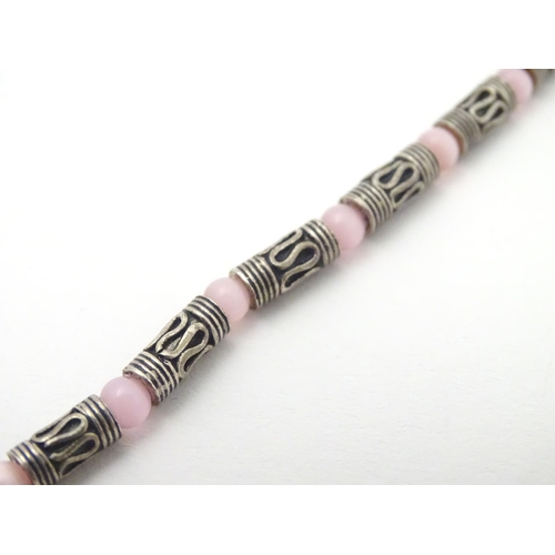 535 - A silver and white metal necklace set with pink cats eye beads. Approx 16'' long