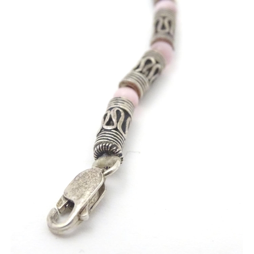 535 - A silver and white metal necklace set with pink cats eye beads. Approx 16'' long