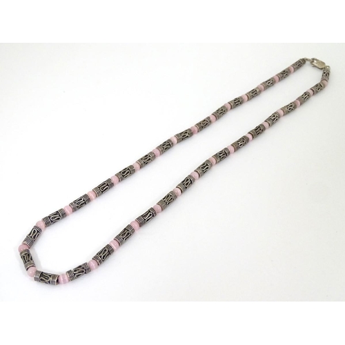 535 - A silver and white metal necklace set with pink cats eye beads. Approx 16'' long