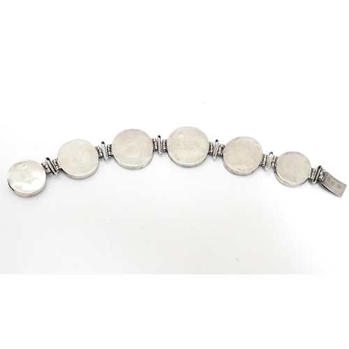 536 - A Victorian white metal bracelet set with 6 locket roundels containing hand painted  studies of bird... 