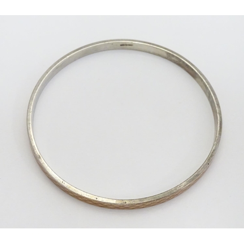 538 - A large silver gilt bracelet / arm bracelet of bangle form with engine turned decoration.