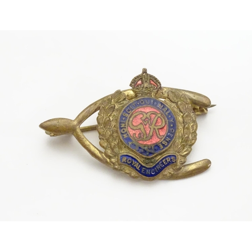 572 - Militaria : a mid-20thC brass Royal Engineers cap badge and lapel badge, the largest 1 5/8