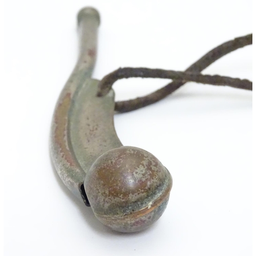 574 - Militaria : an early to mid 20thC Bosun's whistle, with leather lanyard, 4 1/2