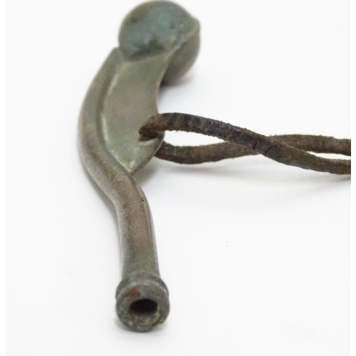 574 - Militaria : an early to mid 20thC Bosun's whistle, with leather lanyard, 4 1/2