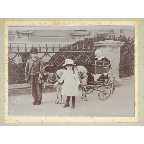 667 - A Victorian monochrome photograph, depicting two children leading a goat pulling a small proportion ... 