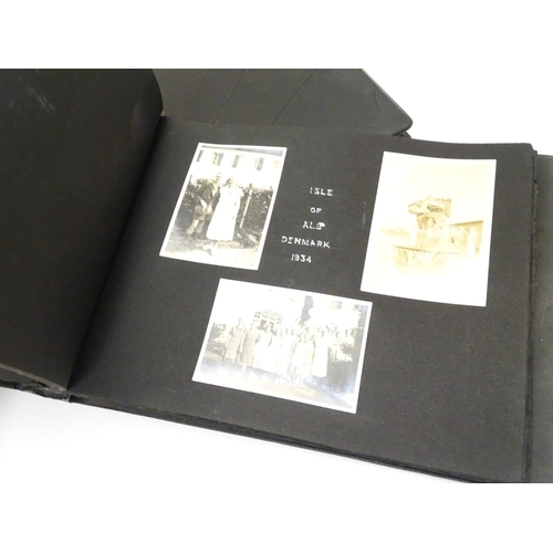 668 - A pre-war photograph album, containing monochrome photographs titled and dated 1929-1937, locations ... 