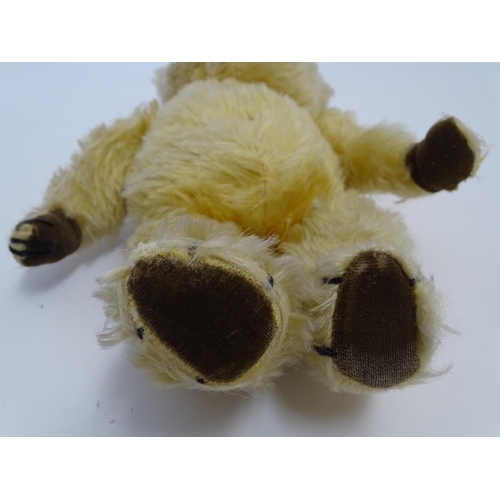 695 - Toy: A mohair teddy bear with articulated limbs, pad paws, stitched claws, and a proud, stitched nos... 