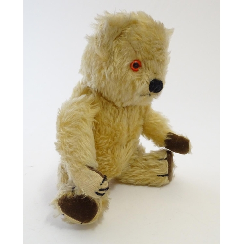 695 - Toy: A mohair teddy bear with articulated limbs, pad paws, stitched claws, and a proud, stitched nos... 