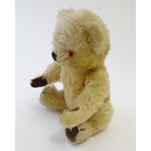 695 - Toy: A mohair teddy bear with articulated limbs, pad paws, stitched claws, and a proud, stitched nos... 