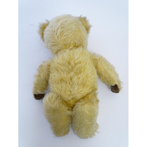 695 - Toy: A mohair teddy bear with articulated limbs, pad paws, stitched claws, and a proud, stitched nos... 