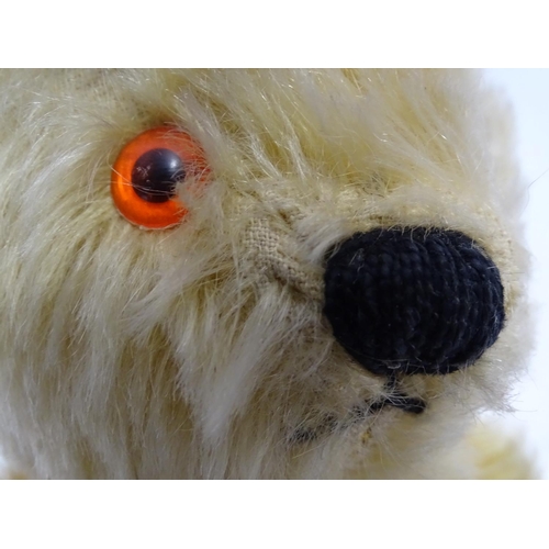 695 - Toy: A mohair teddy bear with articulated limbs, pad paws, stitched claws, and a proud, stitched nos... 