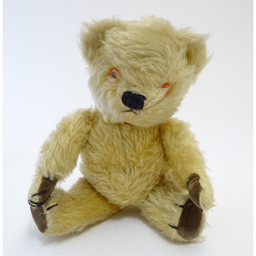 695 - Toy: A mohair teddy bear with articulated limbs, pad paws, stitched claws, and a proud, stitched nos... 