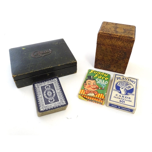 697 - Toys: An early 20thC pokerwork double card box with floral decoration, containing a pack of Club de ... 