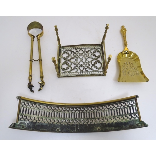 789 - An assortment of Victorian brass fire / stove tools, comprising short tongs and shovel, trivet and b... 