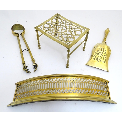 789 - An assortment of Victorian brass fire / stove tools, comprising short tongs and shovel, trivet and b... 