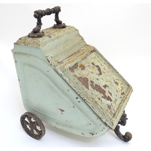 787 - A Victorian tin coal scuttle, the base with wheels and stand, 21