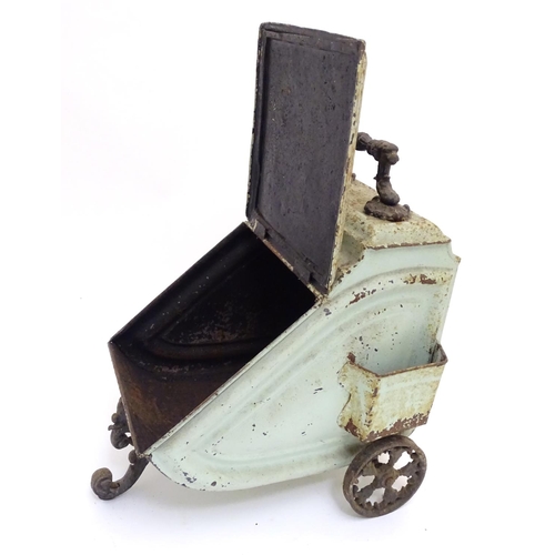 787 - A Victorian tin coal scuttle, the base with wheels and stand, 21