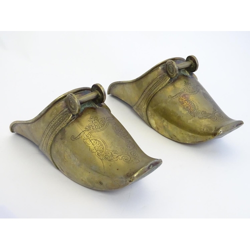 821 - A pair of 19thC South American brass horse riding stirrup shoes with engraved decoration. Approx. 9 ... 