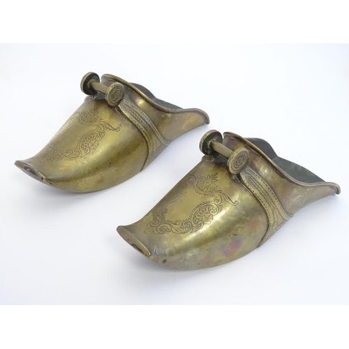 821 - A pair of 19thC South American brass horse riding stirrup shoes with engraved decoration. Approx. 9 ... 