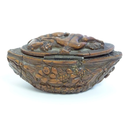 837 - A Continental carved nut snuff box, the hinged lid decorated with a horse and a man carrying a woman... 