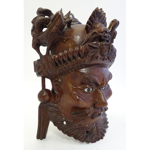 842 - A 20thC Chinese carved hardwood mask with carved dragon detail and inset eyes. Approx. 10 1/4