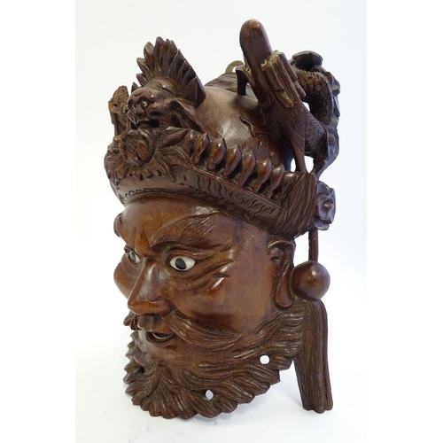 842 - A 20thC Chinese carved hardwood mask with carved dragon detail and inset eyes. Approx. 10 1/4