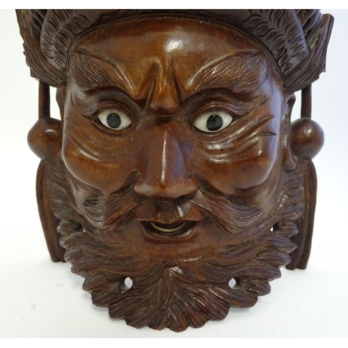 842 - A 20thC Chinese carved hardwood mask with carved dragon detail and inset eyes. Approx. 10 1/4