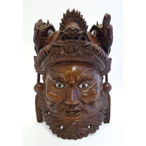 842 - A 20thC Chinese carved hardwood mask with carved dragon detail and inset eyes. Approx. 10 1/4