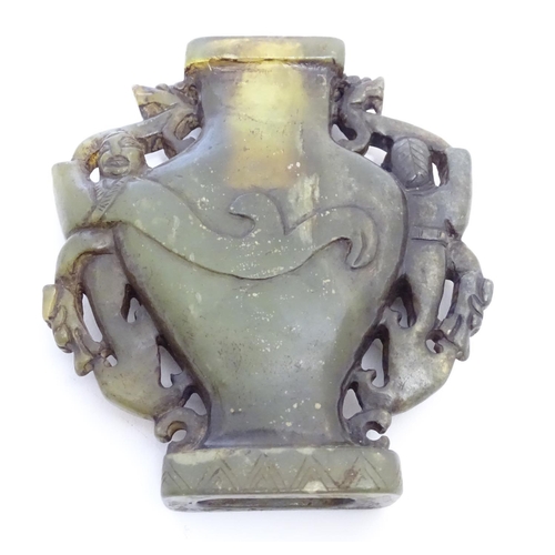 851 - An Oriental soapstone vase of baluster form with stylised figural and animal twin handles. Approx. 4... 